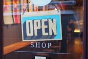 An open sign on a door of a shop